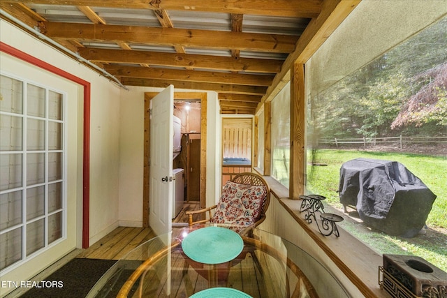 sunroom featuring beamed ceiling