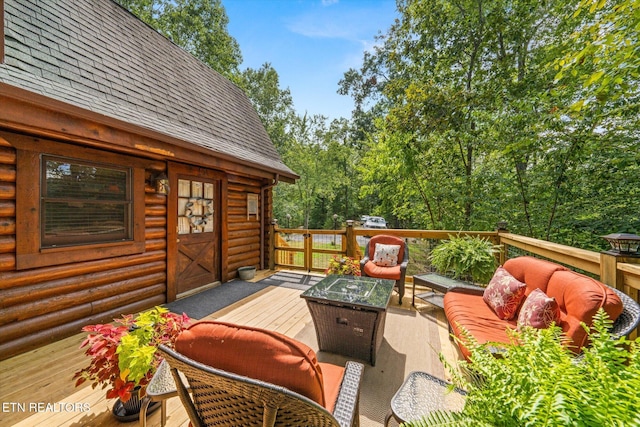 wooden deck with an outdoor living space