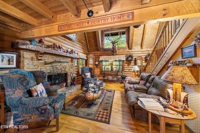 living room with log walls, light wood-type flooring, beam ceiling, and wooden ceiling