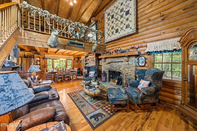 living room with hardwood / wood-style flooring, rustic walls, beam ceiling, high vaulted ceiling, and a stone fireplace