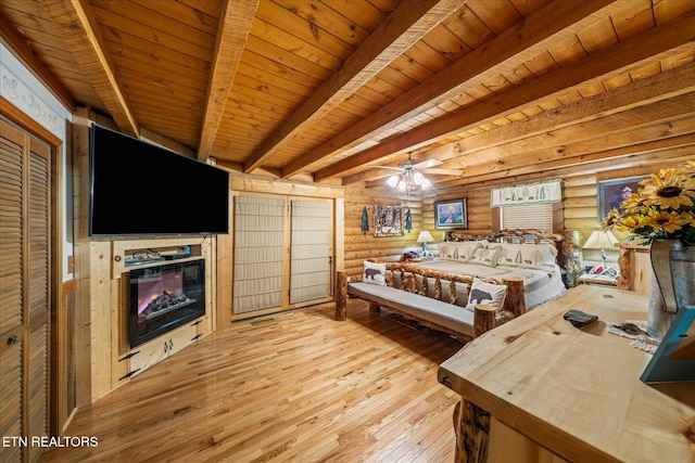 bedroom with ceiling fan, log walls, beam ceiling, and wood ceiling