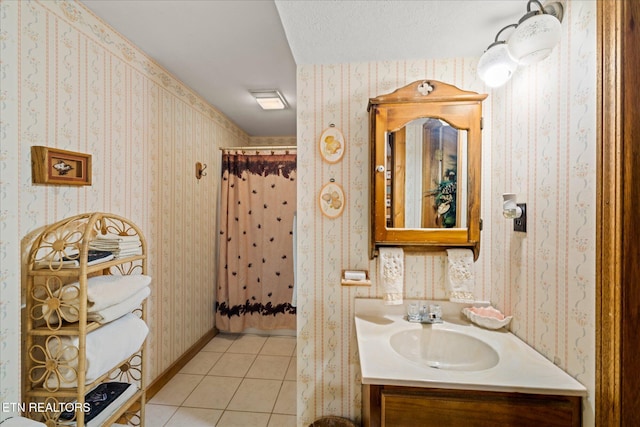 bathroom featuring walk in shower, vanity, tile patterned flooring, and a textured ceiling