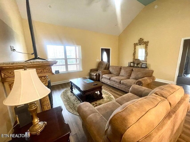 living room with dark hardwood / wood-style floors and lofted ceiling