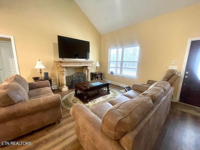 living room featuring hardwood / wood-style flooring and high vaulted ceiling