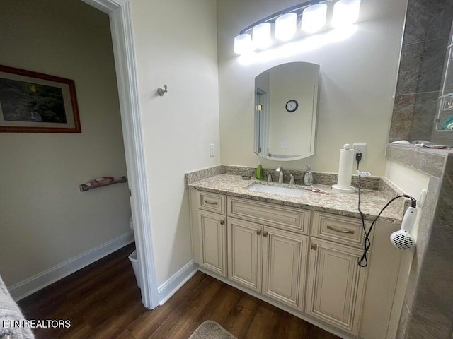 bathroom with vanity, toilet, and hardwood / wood-style floors