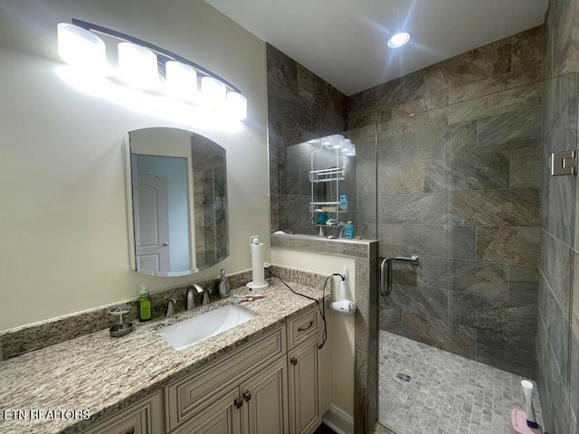 bathroom with vanity and a shower with shower door