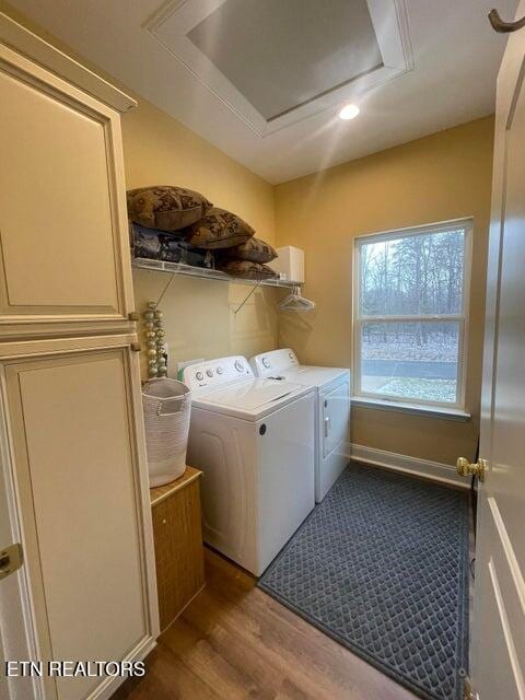 laundry area with washing machine and clothes dryer and wood-type flooring