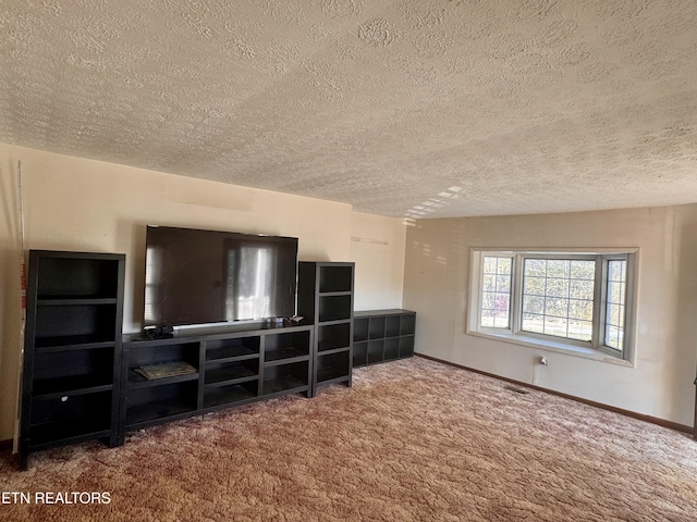 unfurnished living room with carpet floors and a textured ceiling