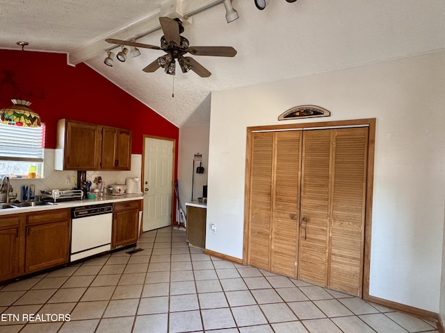 kitchen with sink, dishwasher, vaulted ceiling with beams, a textured ceiling, and decorative backsplash