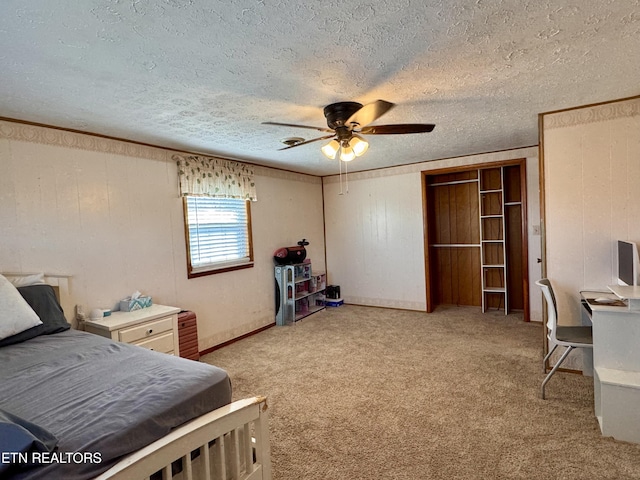 carpeted bedroom with ornamental molding, a textured ceiling, and ceiling fan