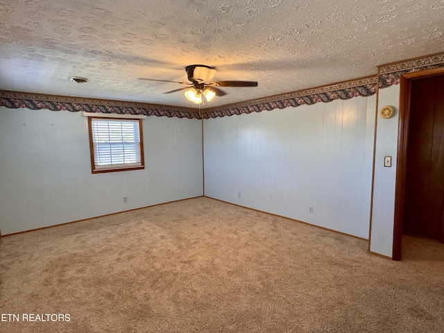 carpeted spare room with ceiling fan and a textured ceiling