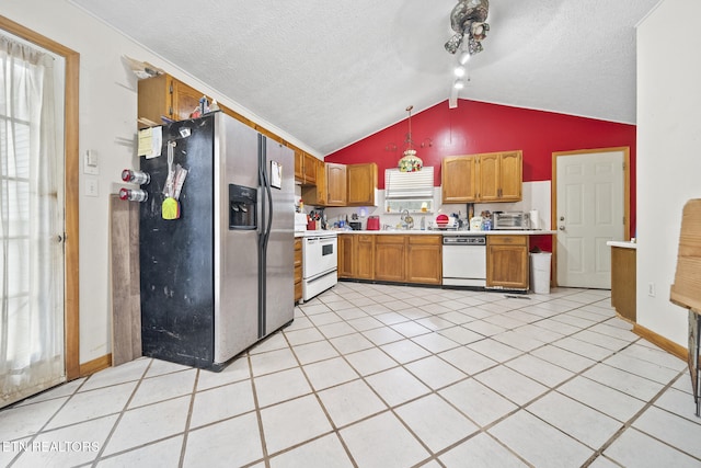 kitchen with pendant lighting, light tile patterned floors, white appliances, lofted ceiling, and a textured ceiling