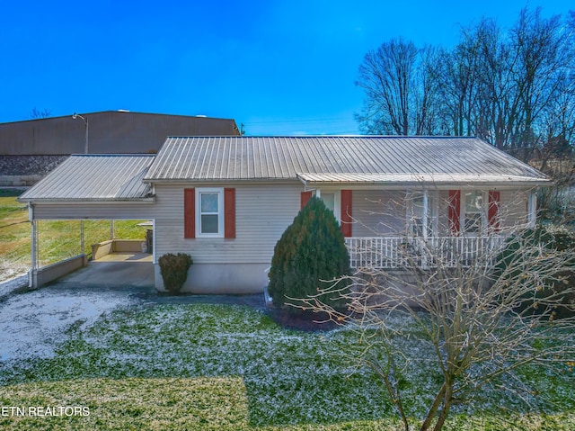 view of front of property with covered porch and a carport