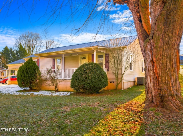 view of front of property with central air condition unit, a front yard, and a porch