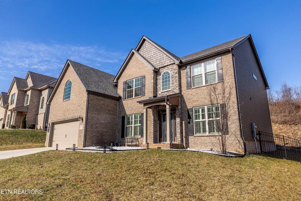 view of front of property featuring a garage and a front lawn