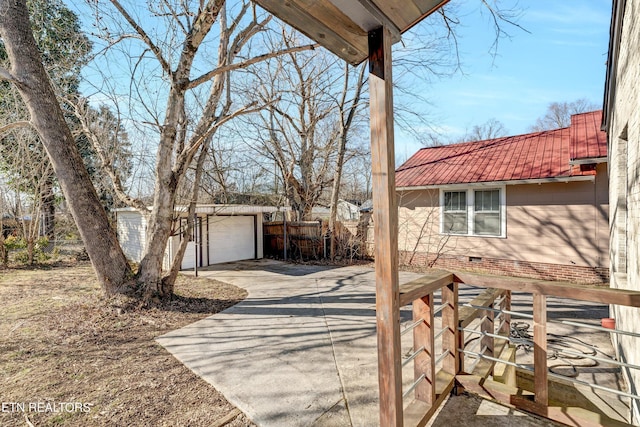 view of property exterior with a garage and an outbuilding