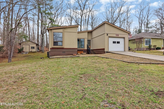 view of front of home with a garage, a storage shed, and a front lawn