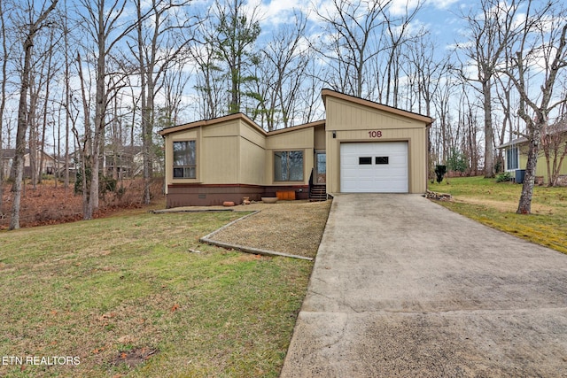 view of front of house with a garage and a front yard