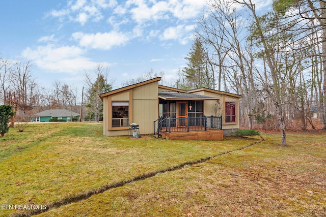 exterior space featuring a sunroom and a front lawn