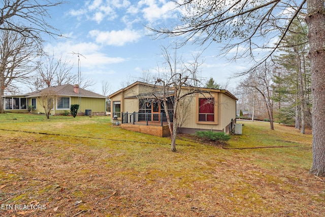 rear view of house featuring a yard