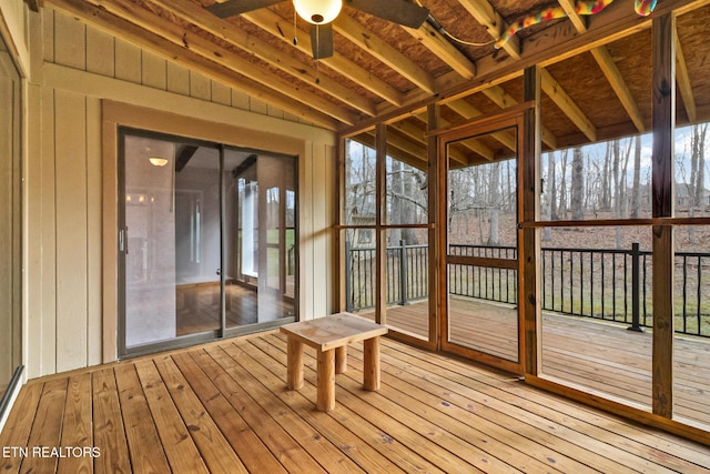 unfurnished sunroom featuring ceiling fan