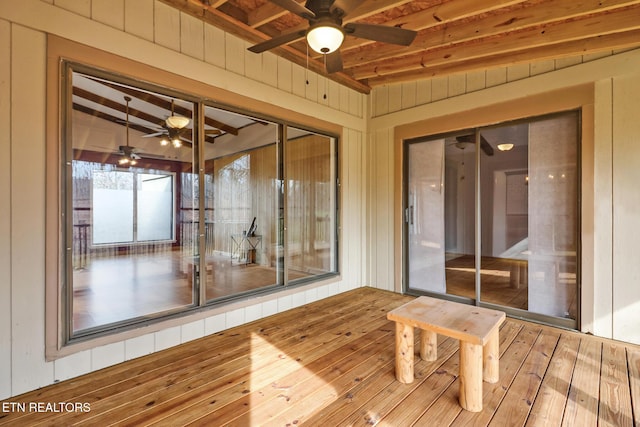 unfurnished sunroom with beam ceiling and ceiling fan