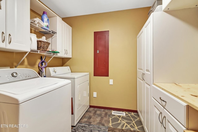 laundry area featuring cabinets, electric panel, and washer and clothes dryer