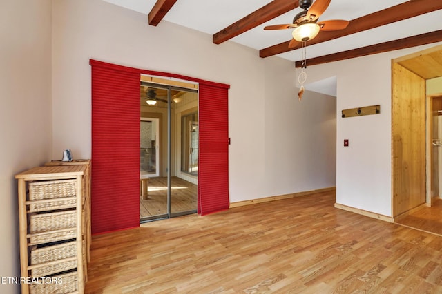 spare room featuring beam ceiling, ceiling fan, and light hardwood / wood-style floors