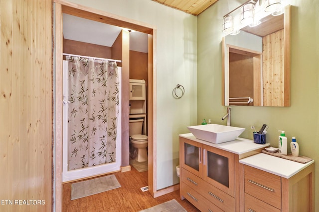 bathroom with vanity, curtained shower, wood-type flooring, and toilet