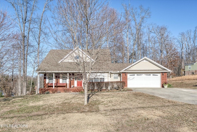 view of front of house featuring a garage, a front yard, and covered porch