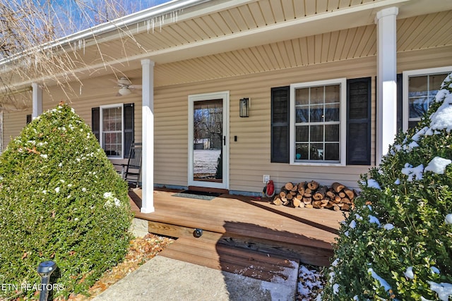 property entrance featuring a porch and ceiling fan