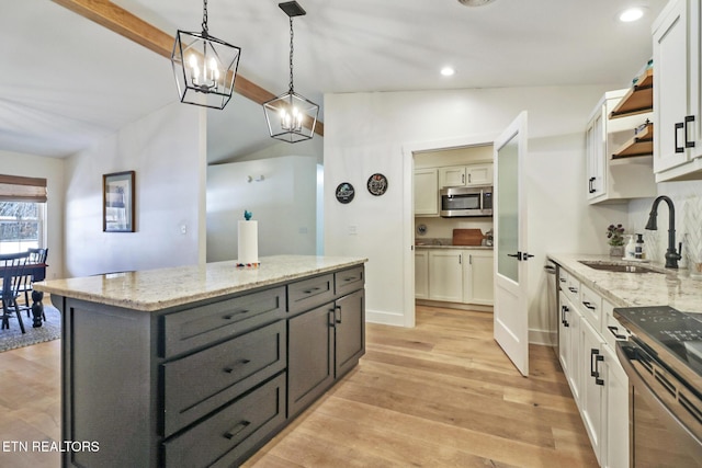 kitchen with white cabinetry, sink, pendant lighting, and stainless steel appliances