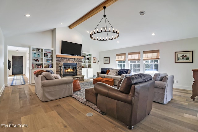 living room with a fireplace, light hardwood / wood-style floors, and vaulted ceiling with beams