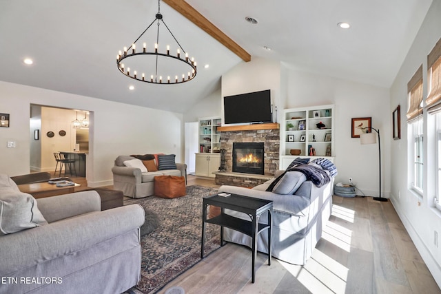 living room featuring built in features, a fireplace, lofted ceiling with beams, and light hardwood / wood-style flooring