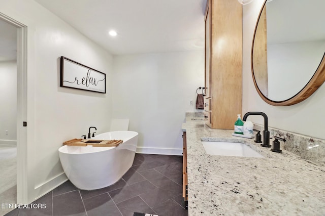 bathroom with vanity, tile patterned flooring, and a bathing tub