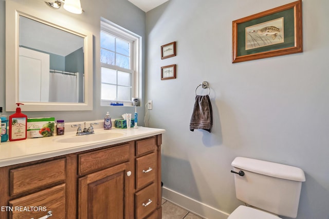 bathroom with tile patterned floors, vanity, and toilet