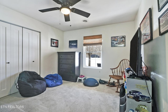 interior space featuring ceiling fan and carpet flooring