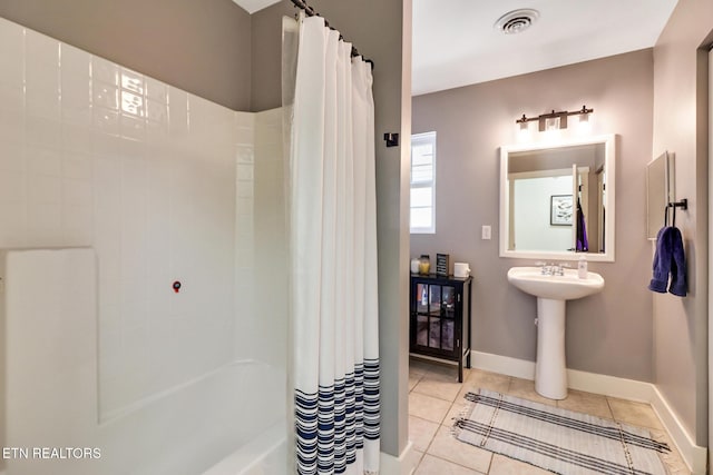 bathroom featuring shower / bath combo and tile patterned floors