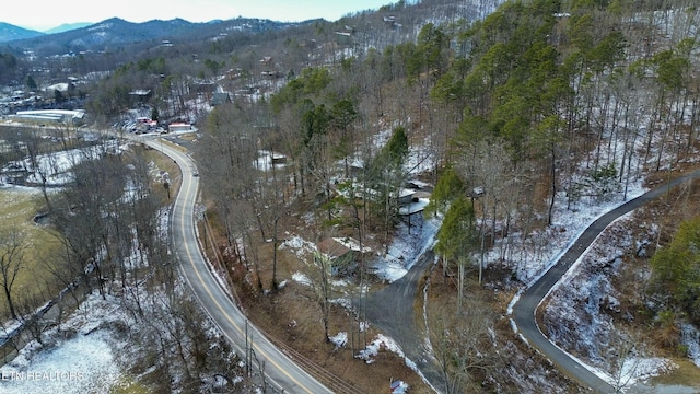 snowy aerial view with a mountain view