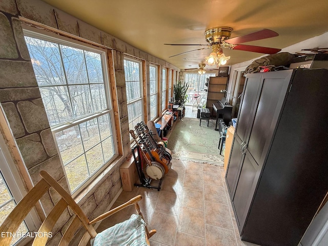 kitchen with fridge, ceiling fan, and light tile patterned flooring