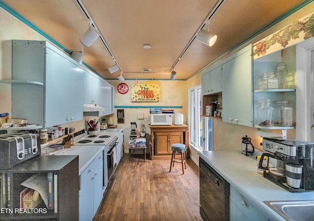 kitchen with under cabinet range hood, white appliances, light countertops, open shelves, and track lighting