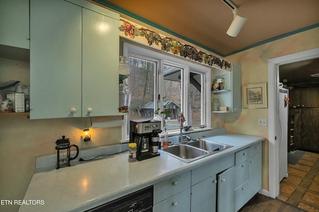 kitchen with dishwashing machine, a sink, light countertops, fridge, and open shelves