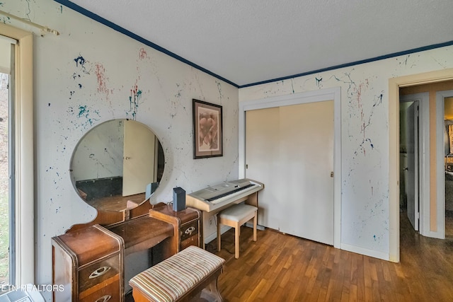 sitting room featuring ornamental molding and wood finished floors