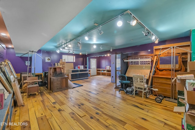 office featuring wood-type flooring and track lighting