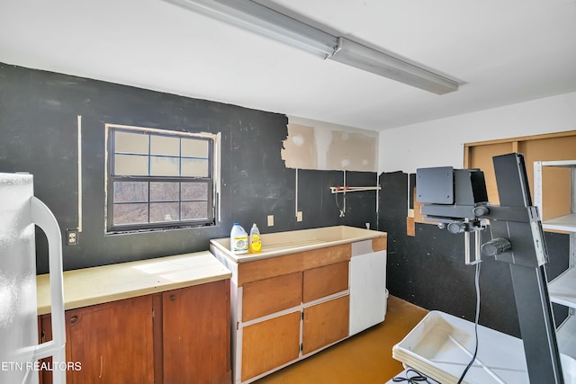 kitchen with brown cabinetry and light countertops