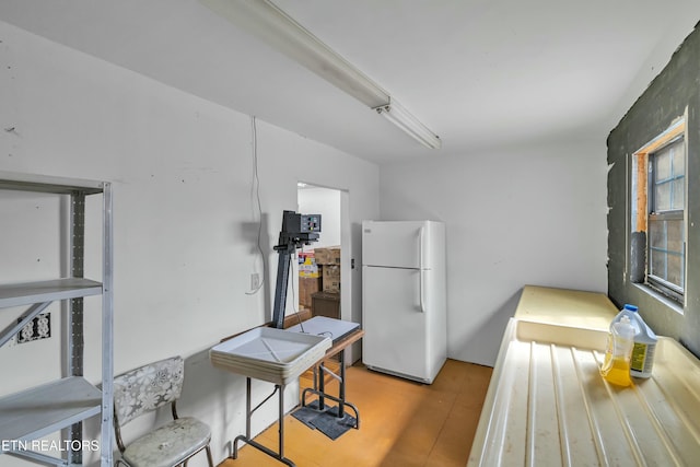 kitchen with wood finished floors and freestanding refrigerator