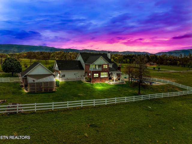 view of front of home featuring a mountain view and a rural view