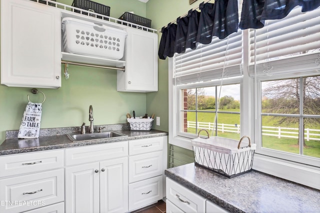 kitchen featuring sink and white cabinets