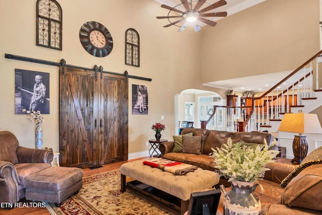 living room with hardwood / wood-style floors and a high ceiling