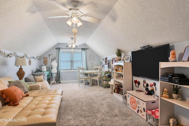 interior space with ceiling fan, lofted ceiling, carpet floors, and a textured ceiling